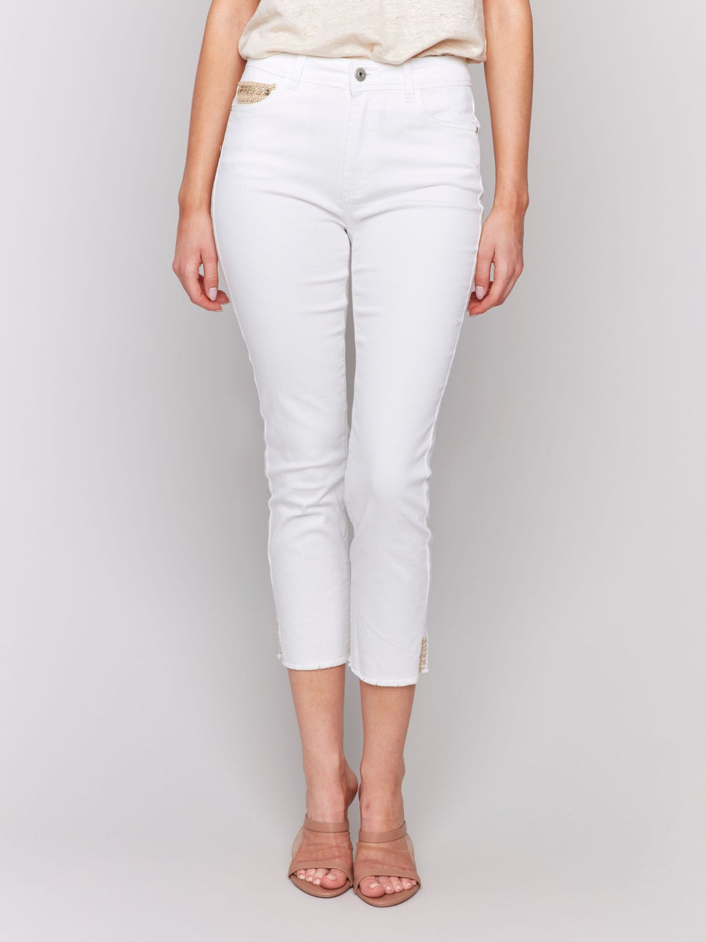 White Pants with Gold Details at Pocket and Hem displayed in a coastal fashion boutique setting.