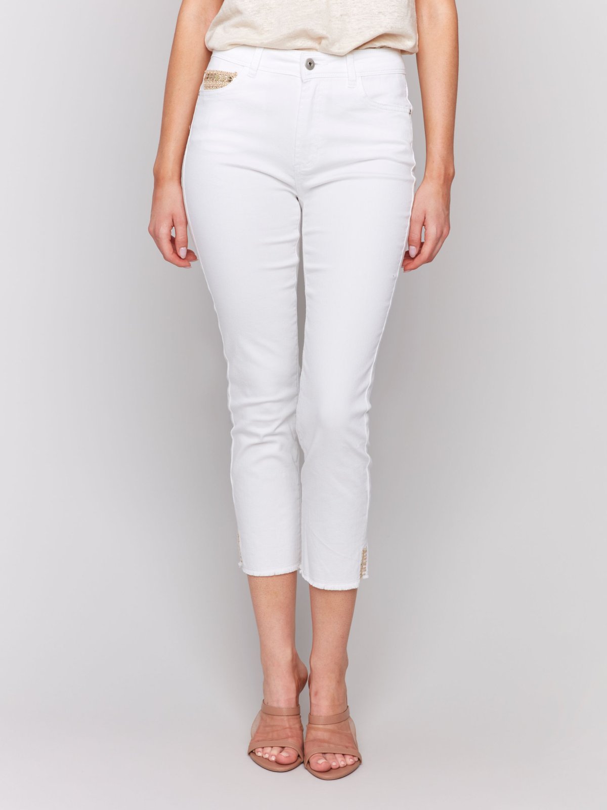 White Pants with Gold Details at Pocket and Hem displayed in a coastal fashion boutique setting.