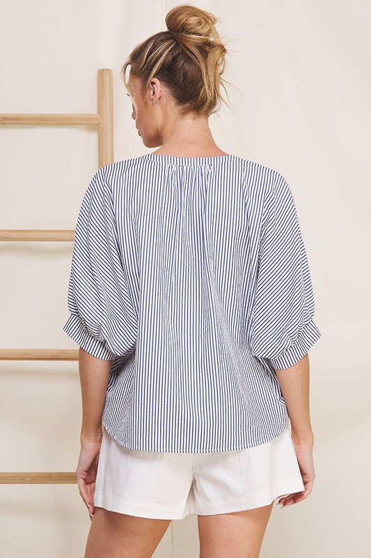 Navy pinstripe seersucker blouse with 3/4 dolman sleeves, perfect for coastal boutique clothing and casual office days.