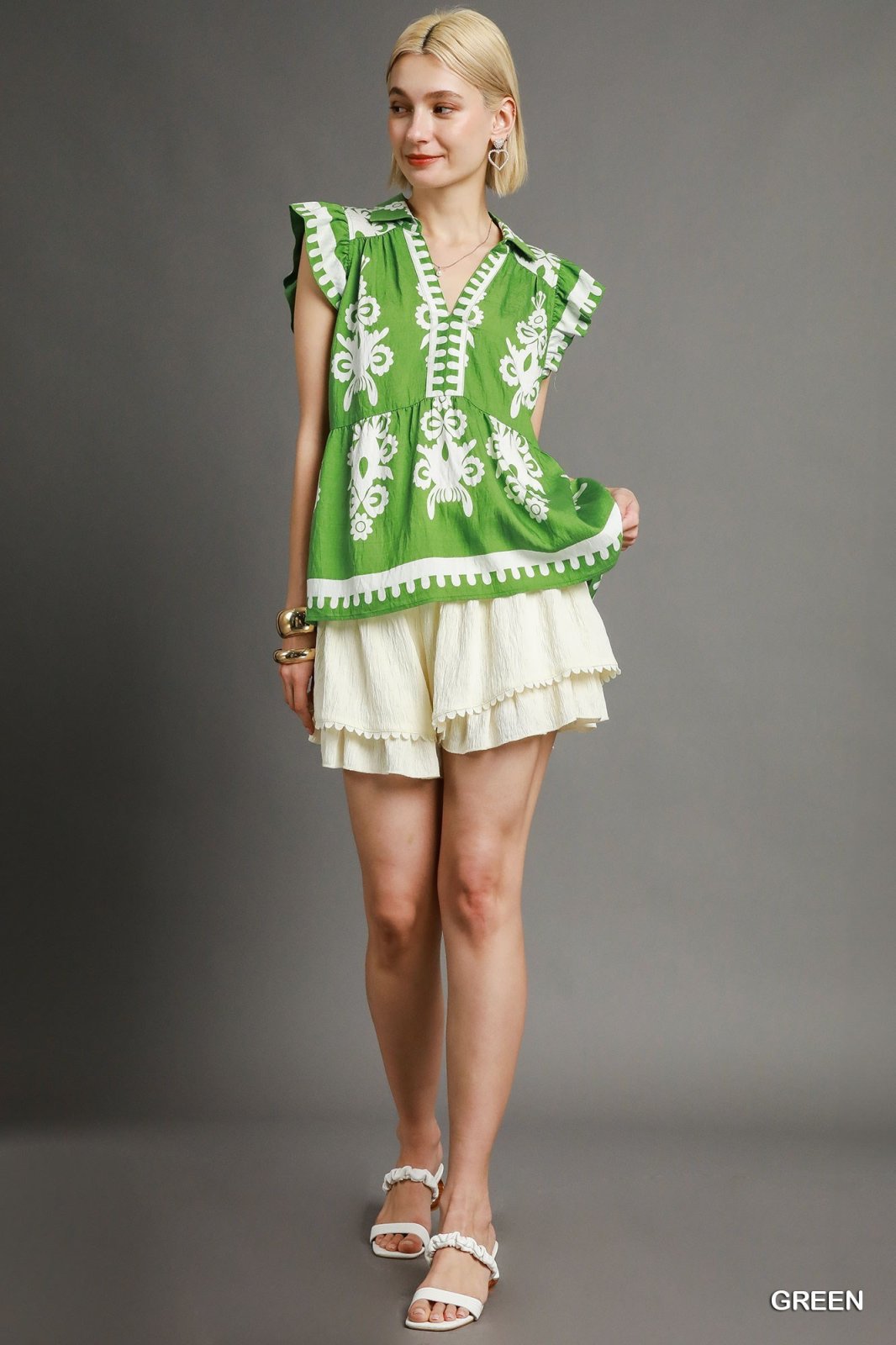 Green Border Print Peplum Blouse styled with ruffles, perfect for coastal boutique clothing and tropical vacation dresses.
