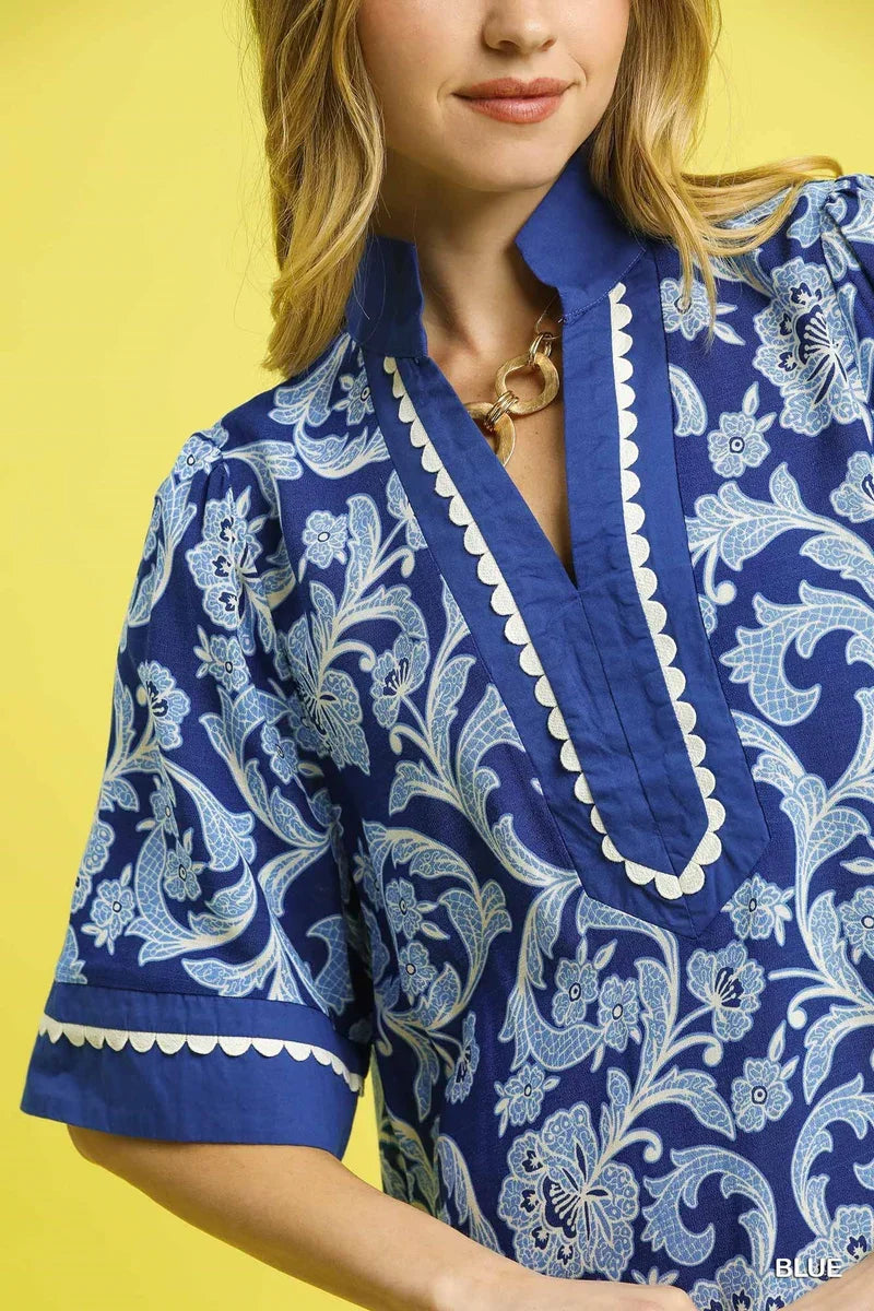 Model wearing the Blue Scallop Tunic Dress showcasing floral print, perfect for coastal boutique clothing and tropical vacations.