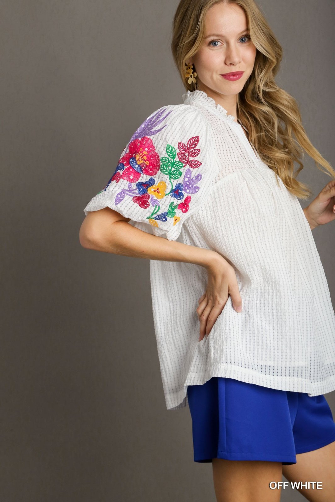 Elizabeth Top in off-white with colorful embroidered sleeves from Raggdoll Boutique, perfect for trendy coastal style.