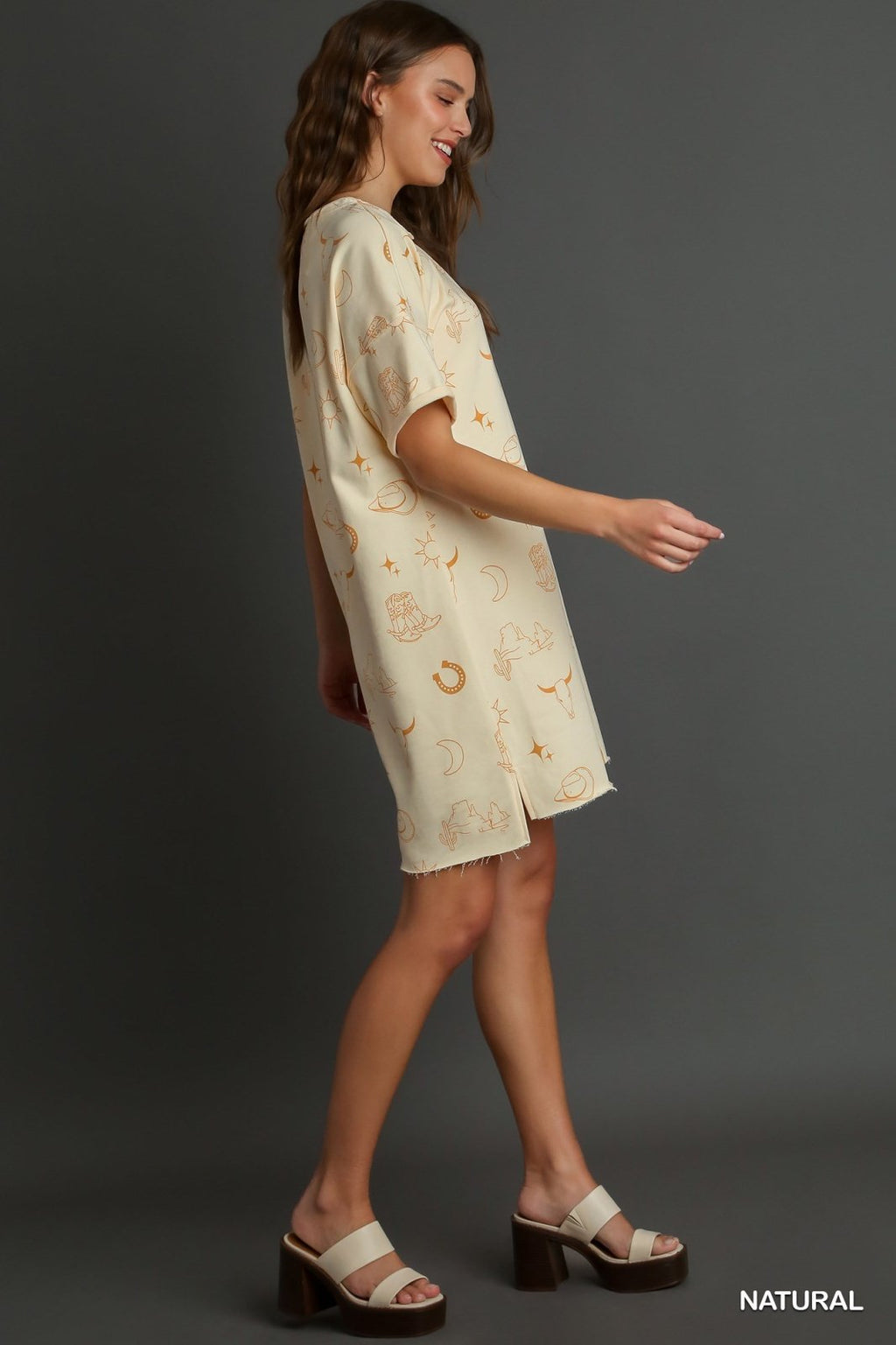 YEEHAW--NATURAL SHORT SLEEVE GRAPHIC DRESS displayed on model, showcasing trendy coastal style from Raggdoll Boutique.