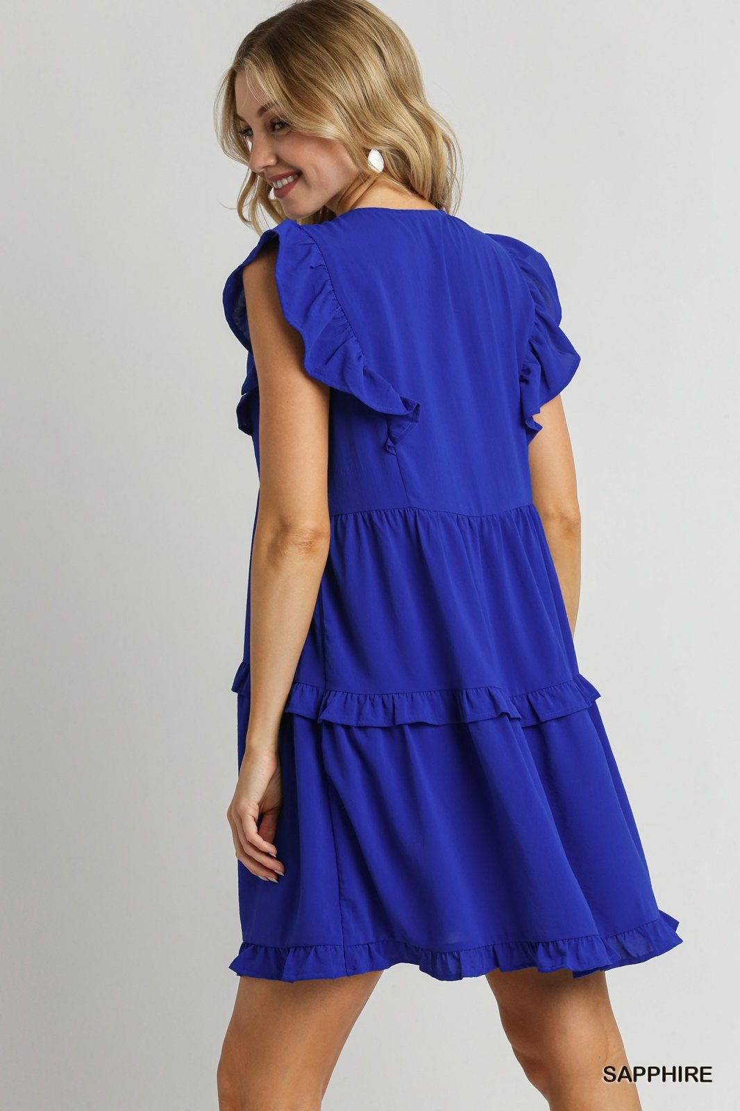 Sapphire blue ruffle tiered dress with V-neck, stylish sleeves, and hidden pockets, perfect for beach outings and tropical vacations.