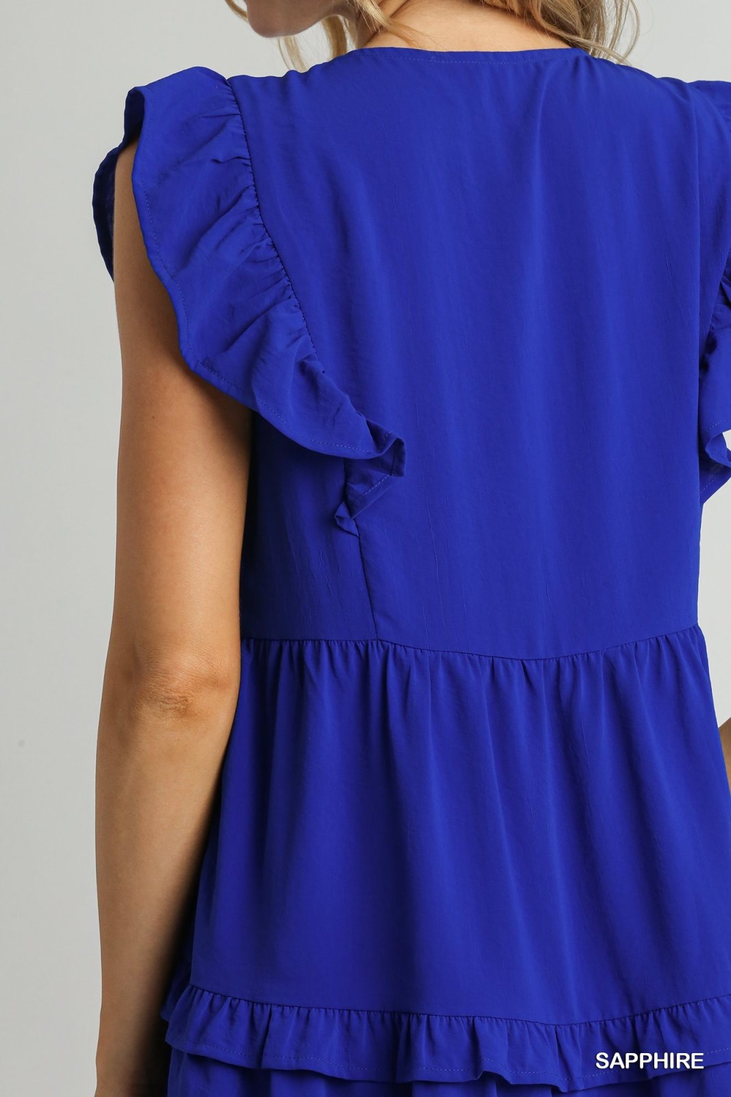 Sapphire blue ruffle tiered dress showcasing V-neck, A-line silhouette, and stylish ruffle sleeves, ideal for beachy occasions.
