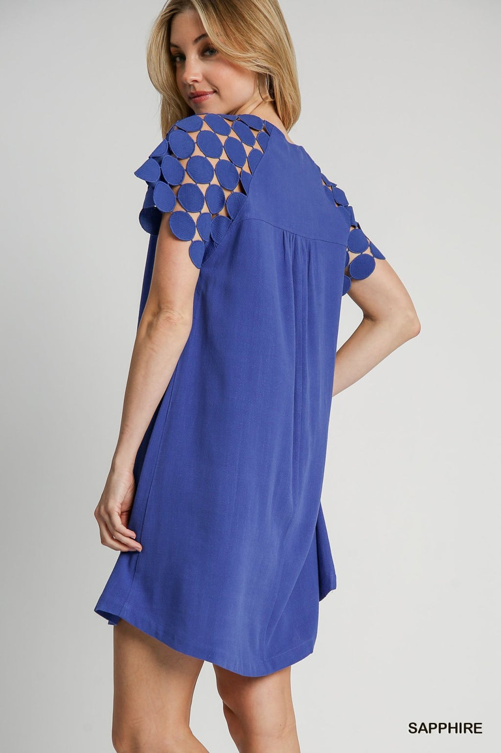 Sapphire dress in vibrant blue, showcasing unique shoulder details, perfect for coastal boutique clothing and beach outings.