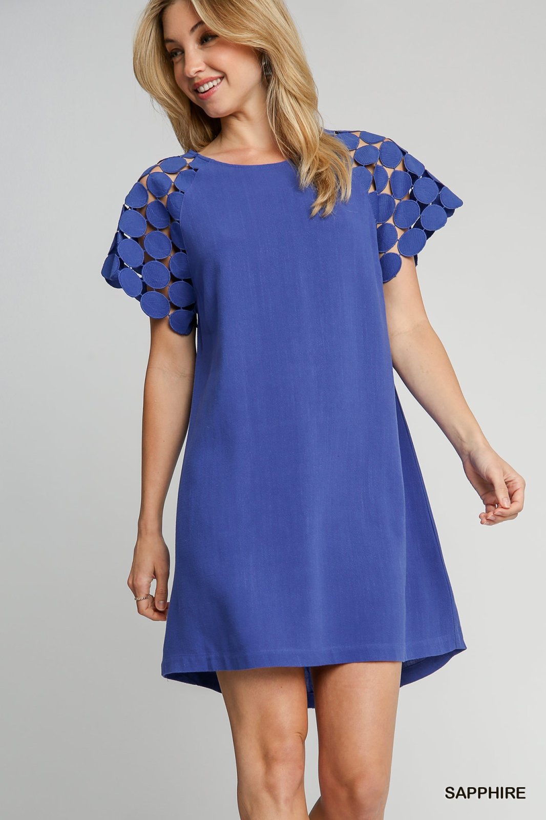 Sapphire dress featuring stylish cutout sleeves, perfect for coastal boutique clothing and tropical vacation dresses.