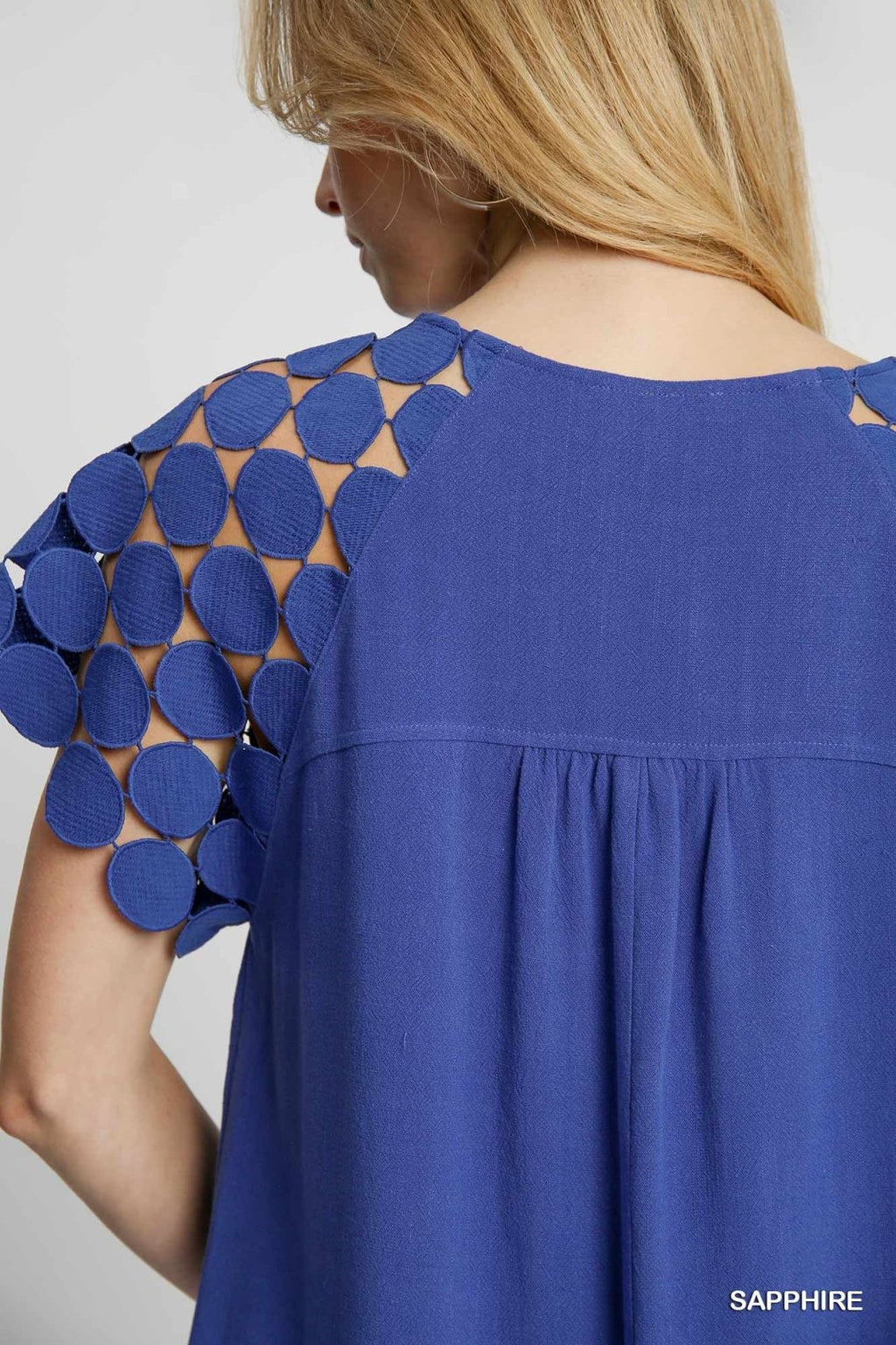 Stylish Sapphire dress showcasing unique dotted sleeves, perfect for coastal boutique clothing and tropical vacations.