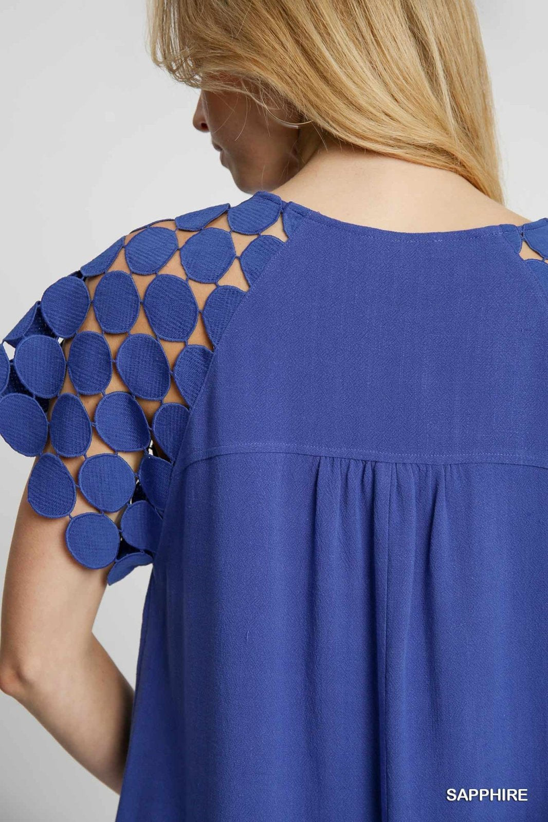 Stylish Sapphire dress showcasing unique dotted sleeves, perfect for coastal boutique clothing and tropical vacations.