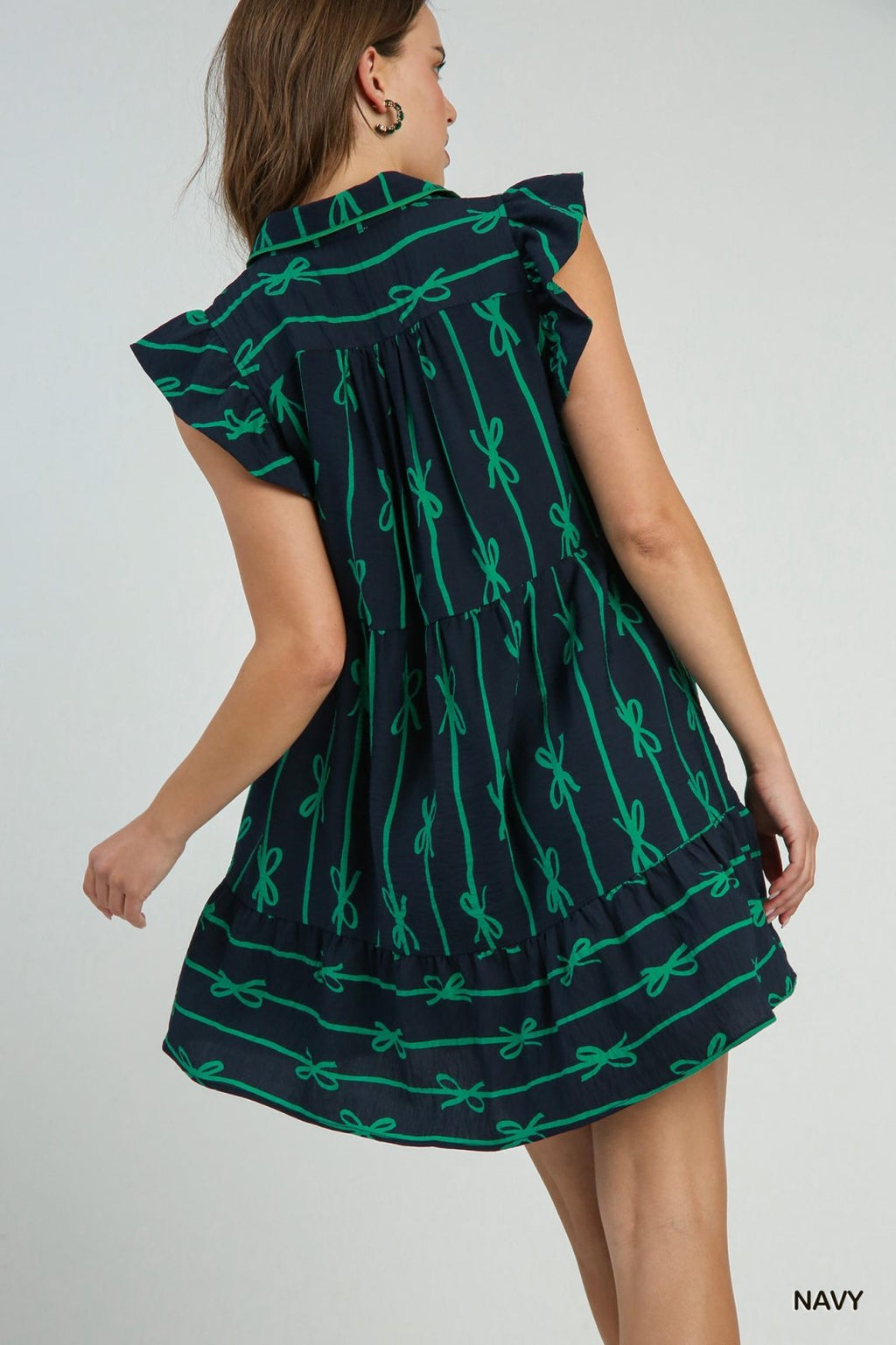 Ribbons and Bows Dress from Raggdoll Boutique, featuring a trendy coastal style with a navy and green bow print.