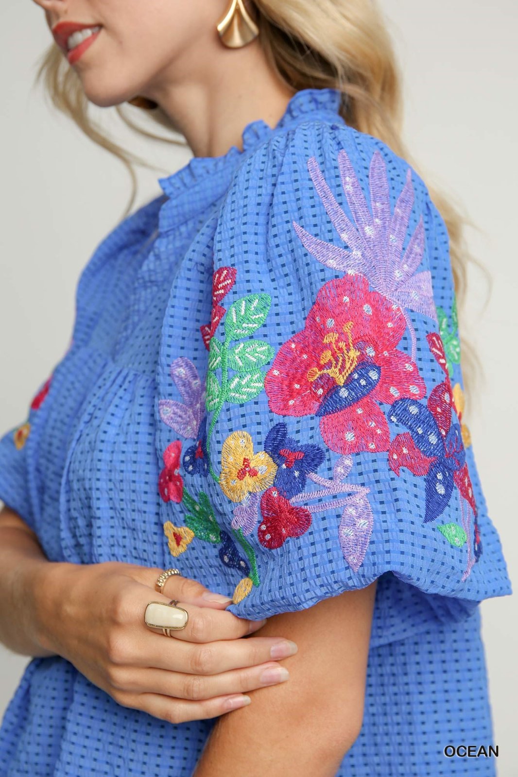 Georgia Dress showcasing vibrant floral embroidery, perfect for trendy coastal style at Raggdoll Boutique.