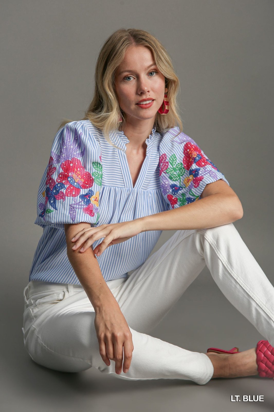 Model wearing Hazel Top from Raggdoll Boutique, featuring colorful floral design, perfect for summer outfits Texas.