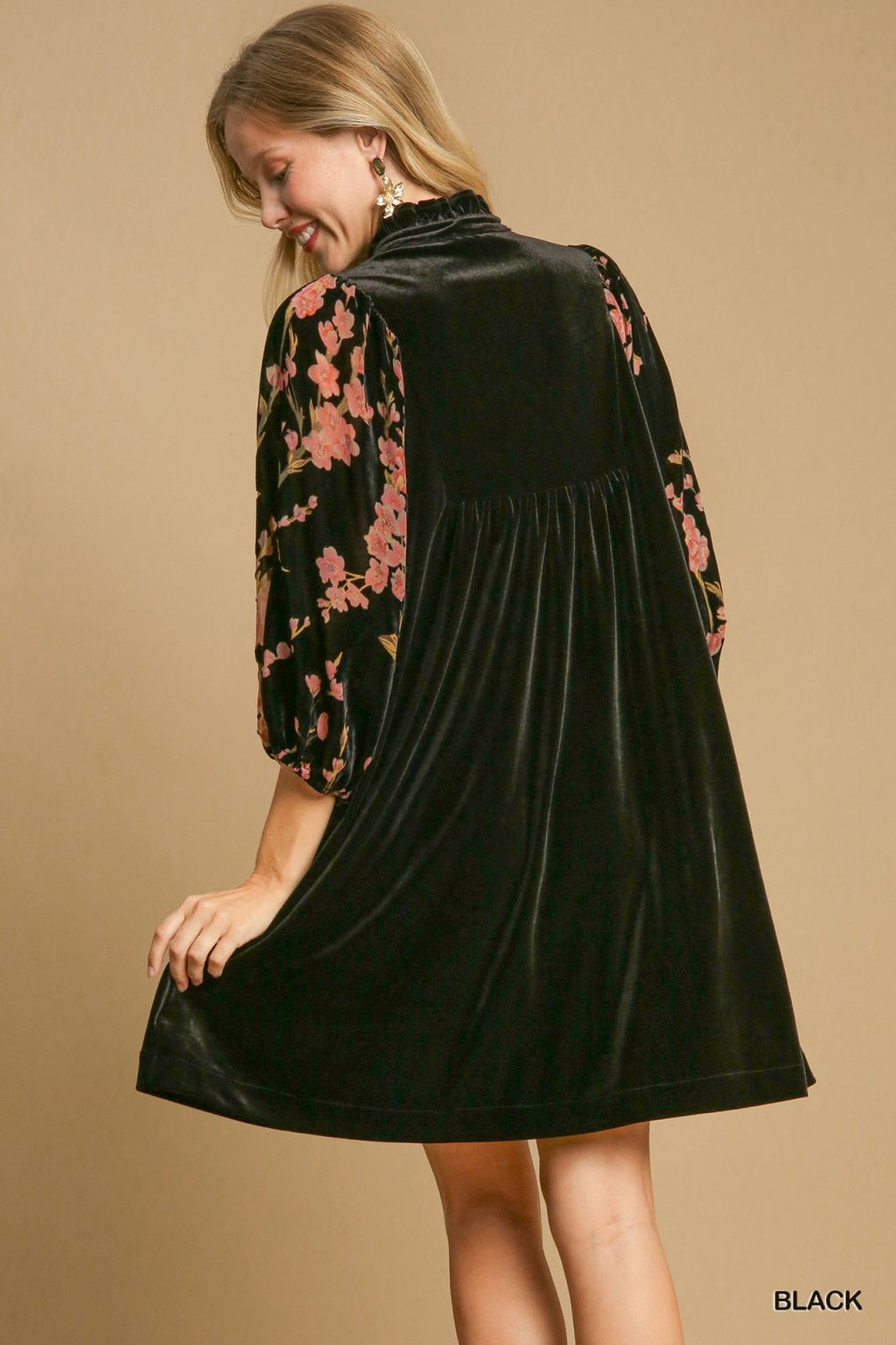 Stylish black velvet dress with floral sleeves, perfect for coastal boutique clothing and tropical vacation outfits.
