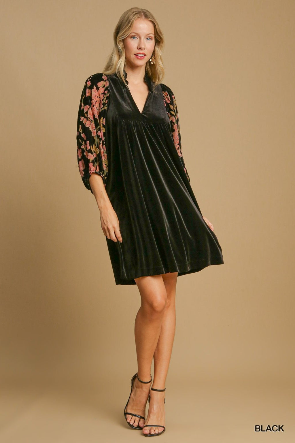 Floral sleeve black velvet dress perfect for tropical vacations, available at a coastal boutique specializing in women's fashion.