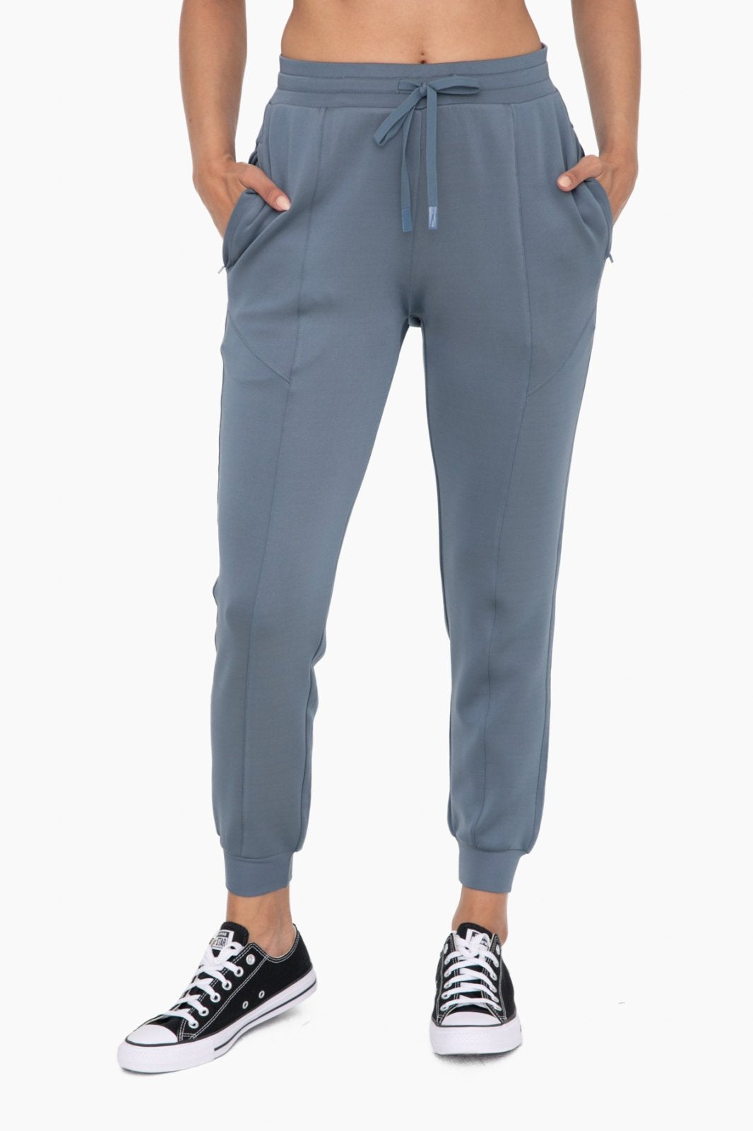 Blue cuffed joggers with zipper pockets, perfect for coastal boutique clothing and stylish women's bottoms.
