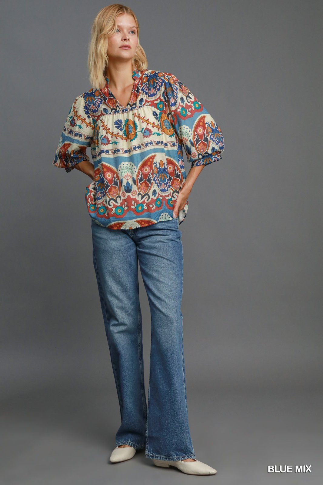 Stylish women's blue mix top paired with flared jeans, perfect for coastal boutique clothing and tropical vacation outfits.