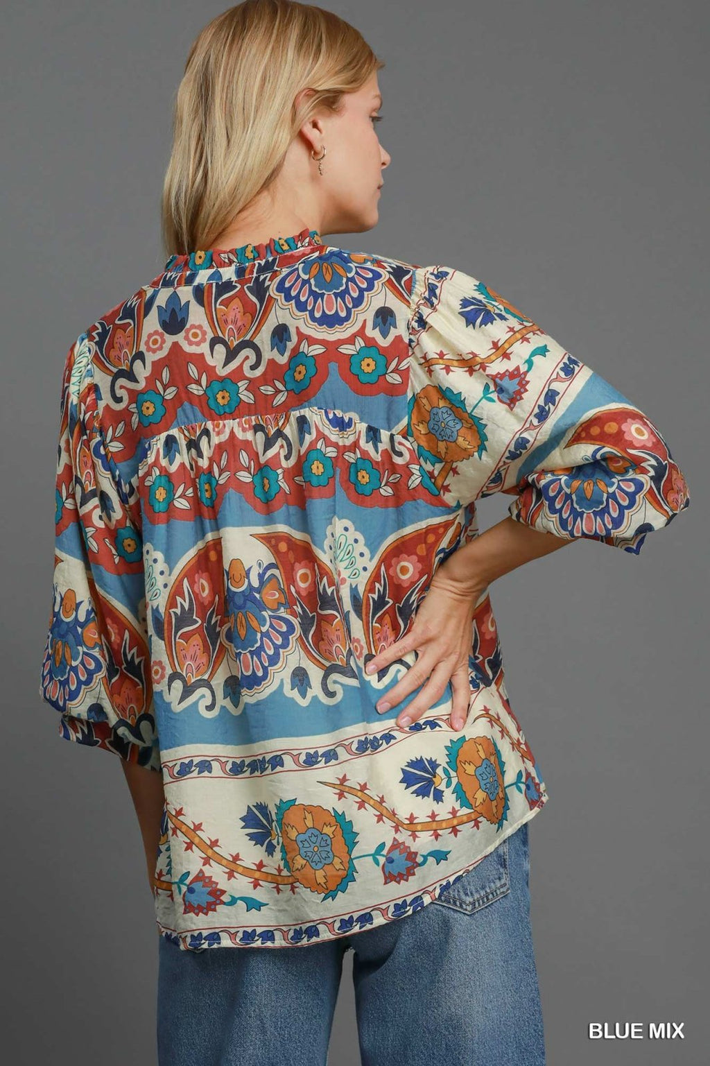 Stylish fall top from a coastal boutique, perfect for tropical vacations. Fashionable women's top in vibrant floral patterns.