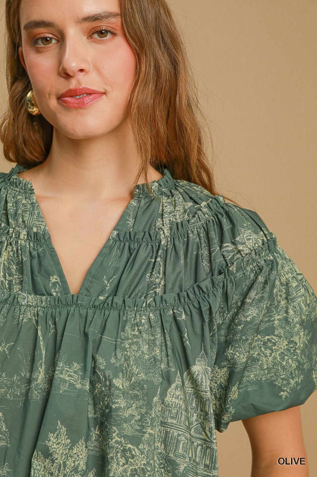Stylish olive top from a Port Aransas boutique, featuring a relaxed fit, perfect for coastal outings and tropical vacations.