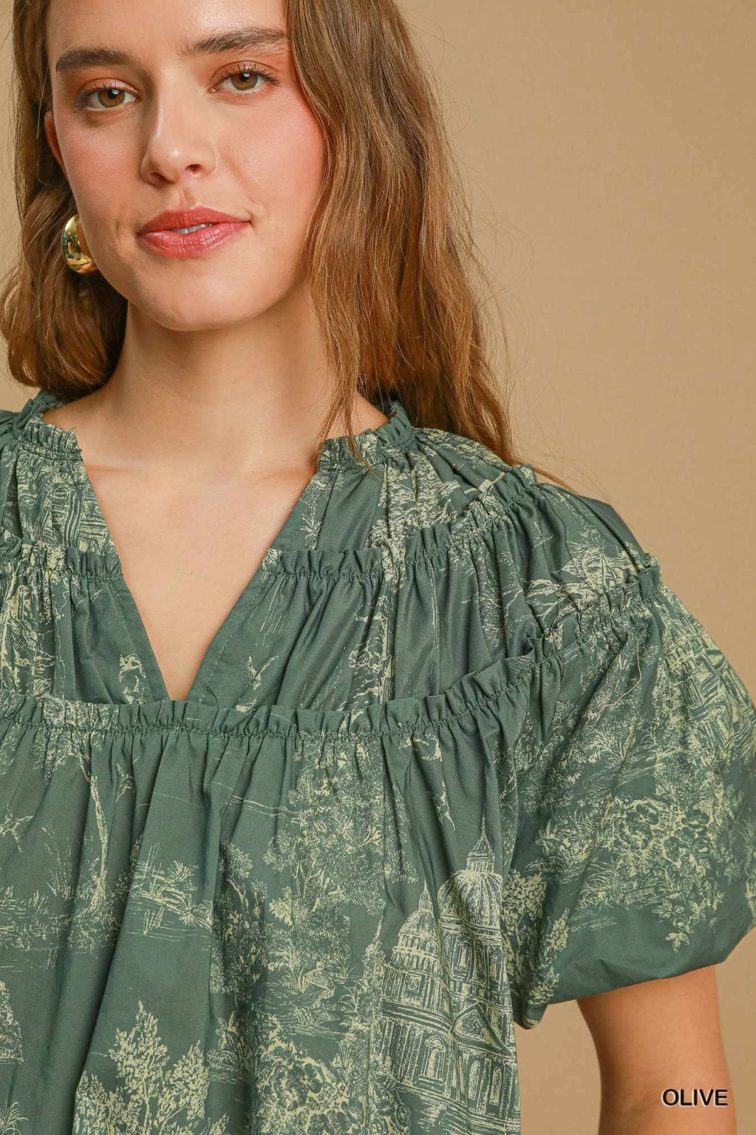 Stylish olive top from a Port Aransas boutique, featuring a relaxed fit, perfect for coastal outings and tropical vacations.