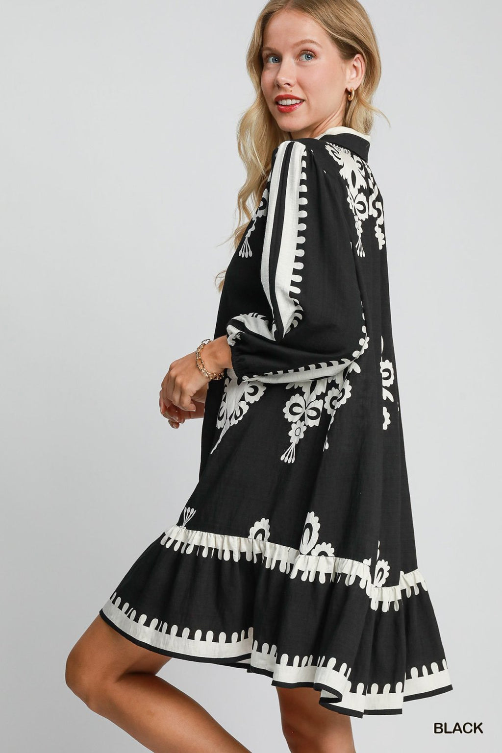 Melinda Dress featuring a stylish black design with white detailing, perfect for coastal boutique clothing and beach outings.