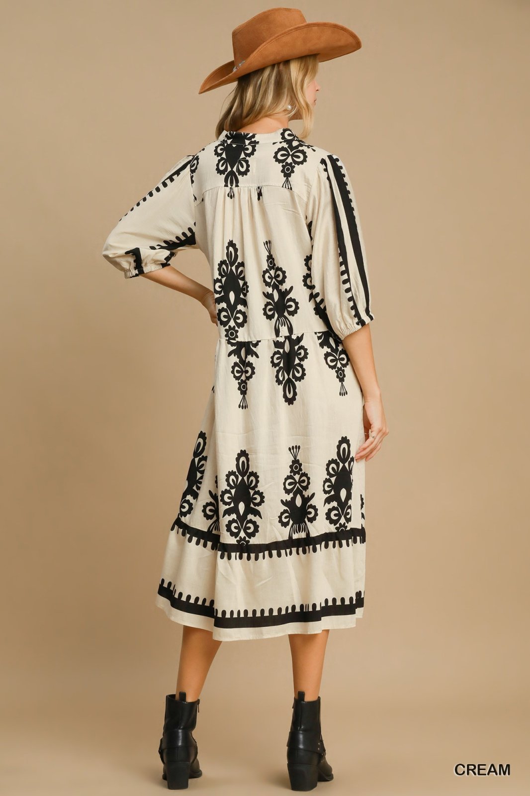 Stylish Cream Abstract Print Midi Dress with black detailing, perfect for coastal boutique clothing and tropical vacations.