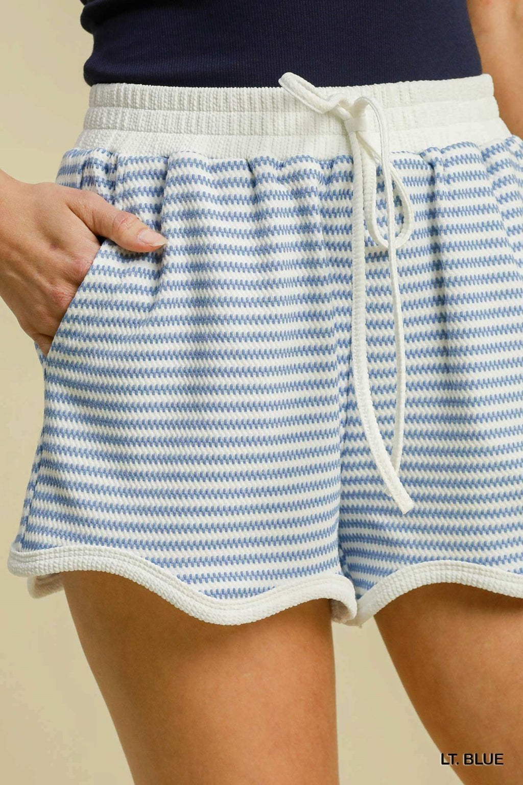 Light blue striped shorts perfect for spring and summer, ideal for coastal boutique clothing and stylish women's bottoms.