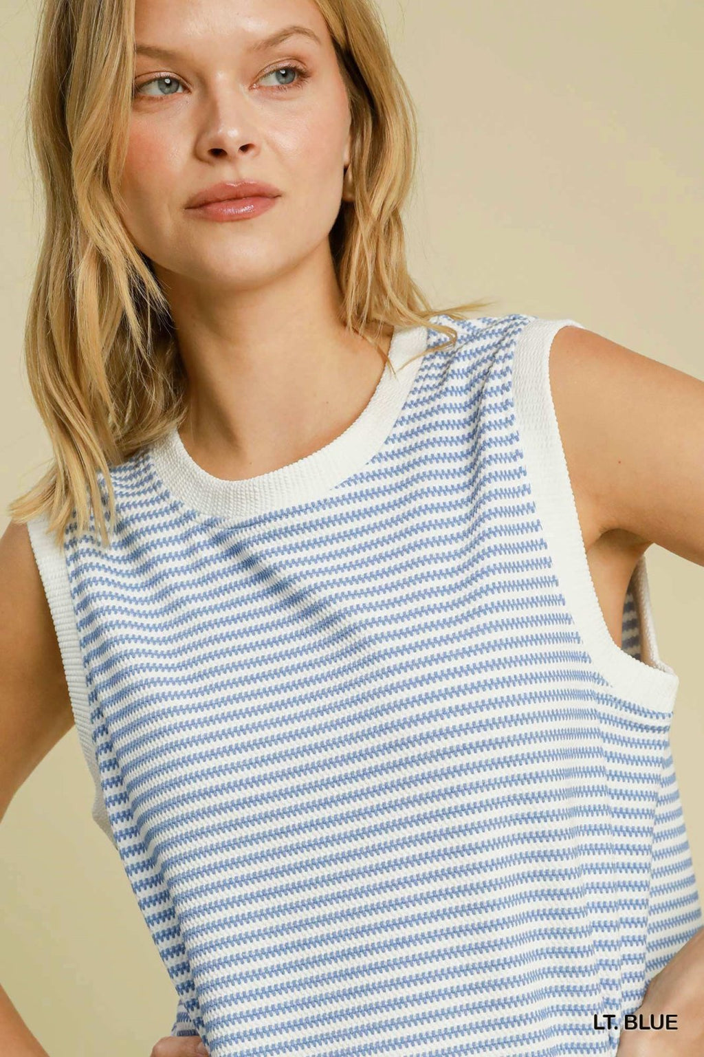 Stylish lightweight blue and white striped sleeveless top from a coastal boutique, perfect for summer adventures.