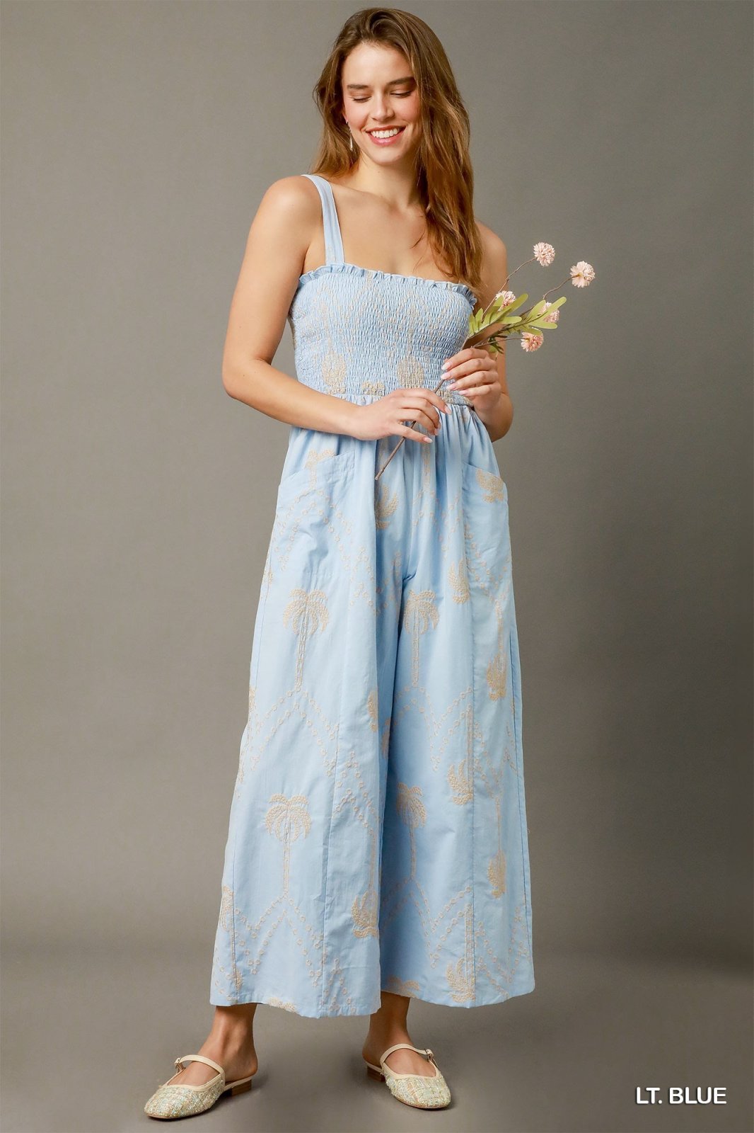 Light blue boho smocked wide-leg jumpsuit from a Port Aransas boutique, perfect for tropical vacations and casual outings.