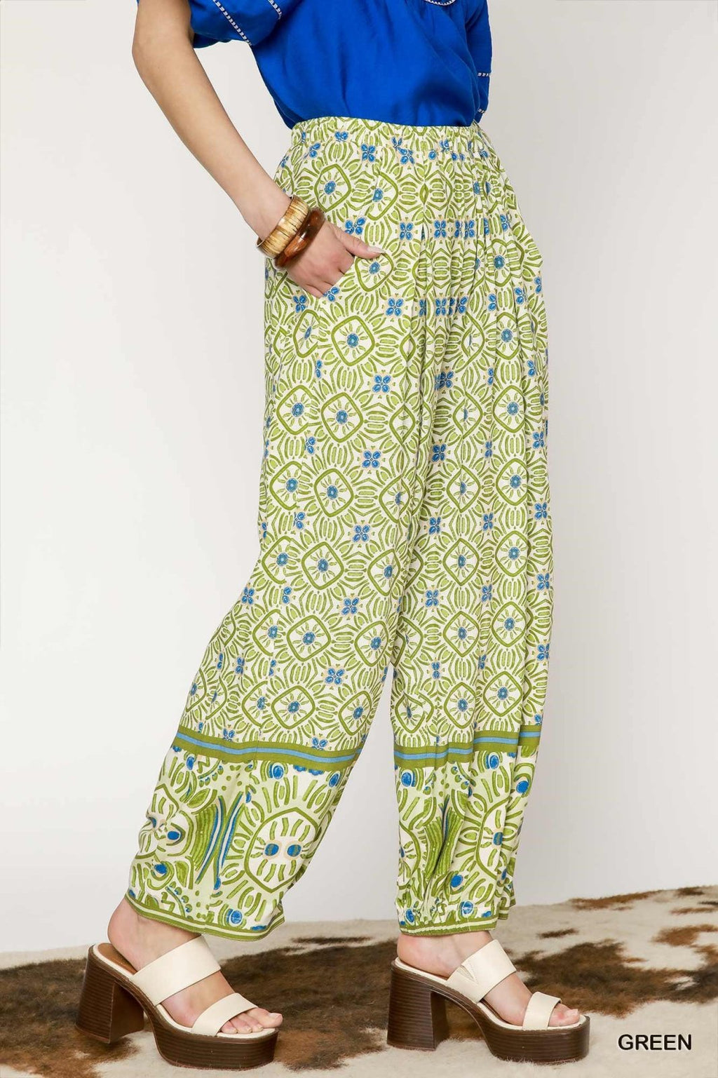 Stylish mixed print palazzo pants in green, perfect for casual and dressier occasions, from a coastal boutique offering curated women's fashion.