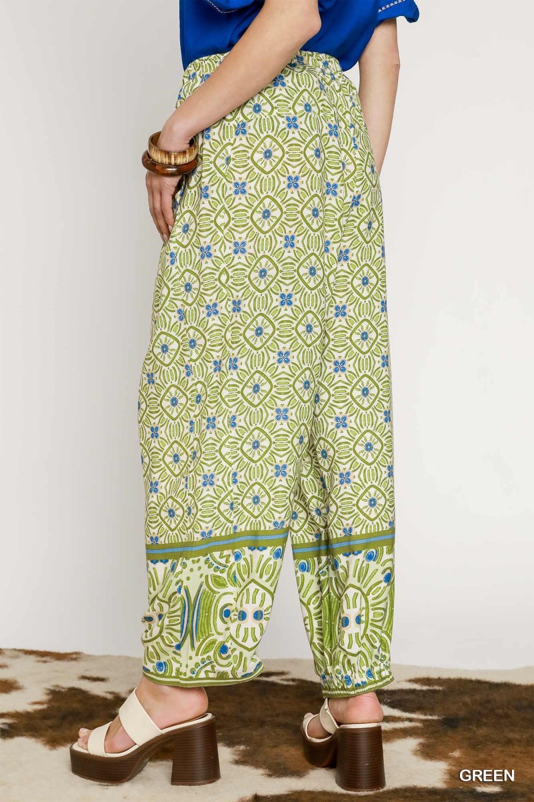 Stylish mixed print palazzo pants in green from coastal boutique clothing, perfect for casual or dressy occasions.