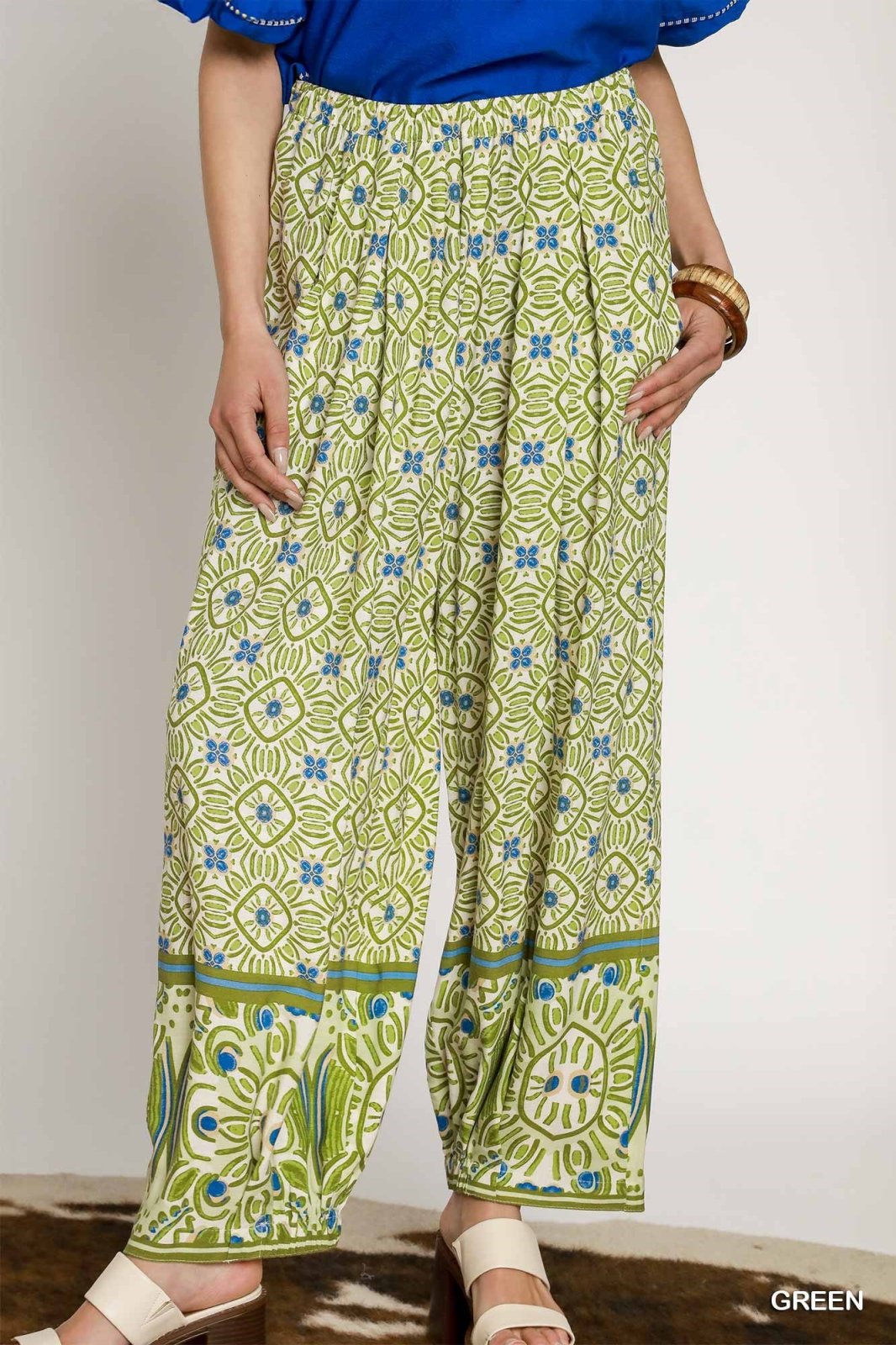 Stylish mixed print palazzo pants in green, ideal for casual and dressy occasions from a coastal boutique clothing shop.