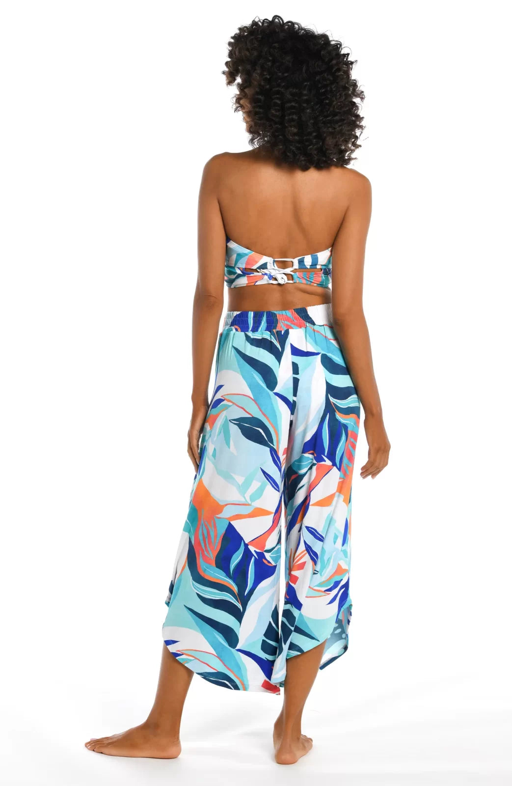 A model showcases COASTAL PALMS PALAZZO PANTS at Raggdoll Boutique, highlighting trendy coastal style and summer outfits Texas.