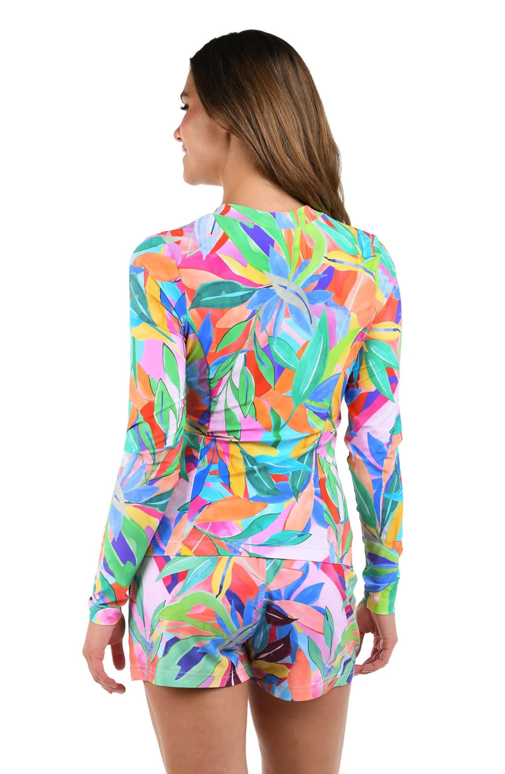 Stylish woman in a colorful Tropi-flag half-zip rash guard, ideal for coastal boutique clothing and tropical vacation dresses.