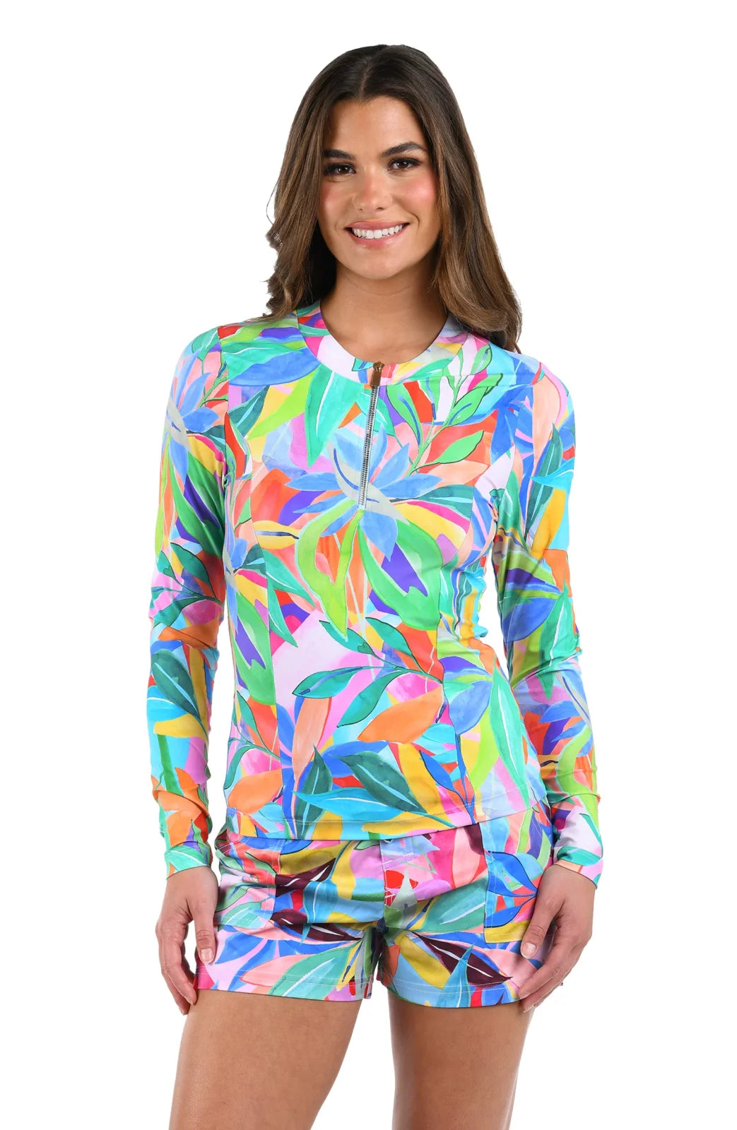 Model wearing Tropi-flag Half-Zip Rash Guard, a colorful swimwear piece from a coastal boutique for tropical vacations.