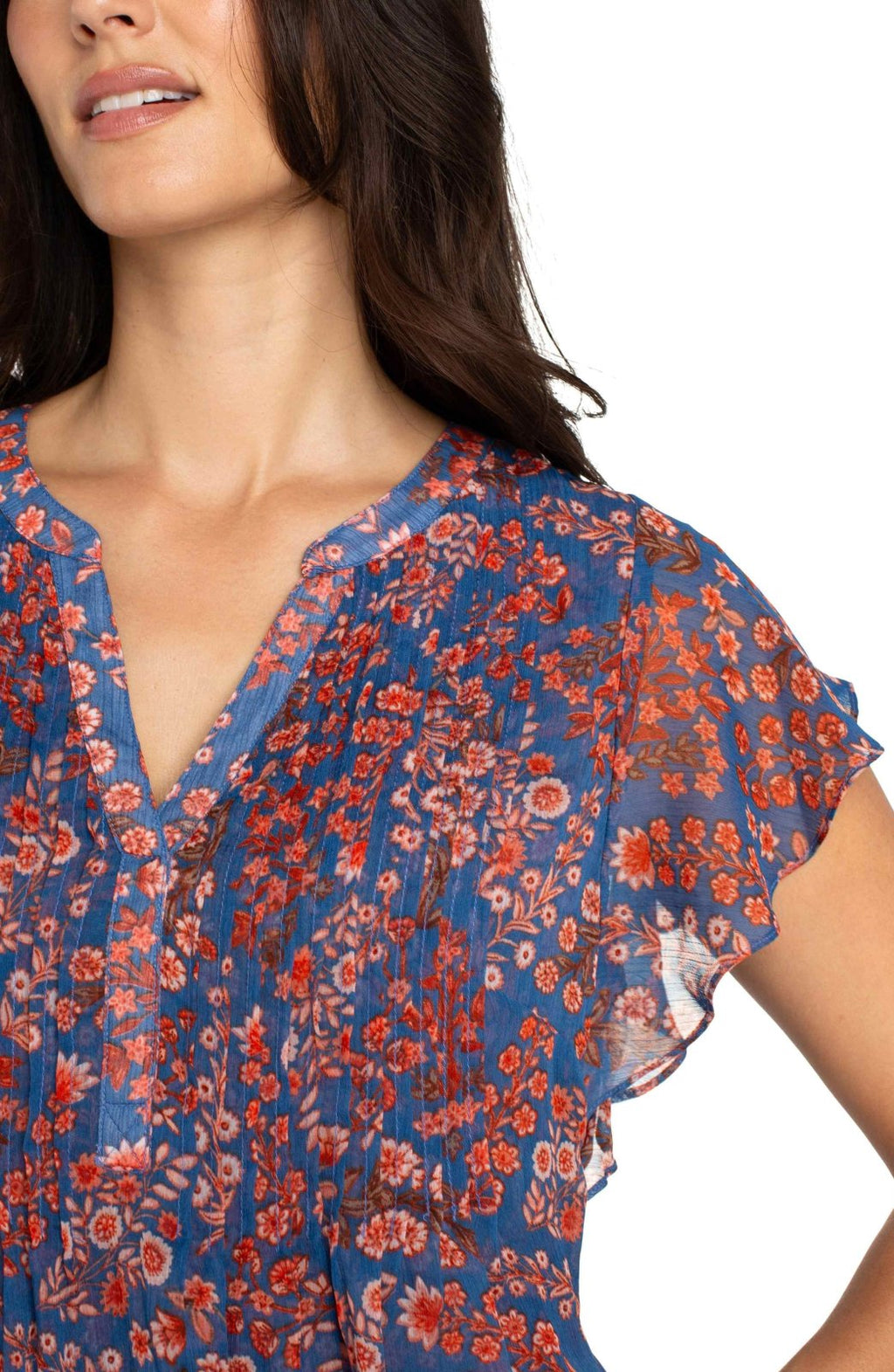 Stylish Liverpool blue and pink flutter sleeve top from a coastal boutique, ideal for tropical vacations and curvy fashion.