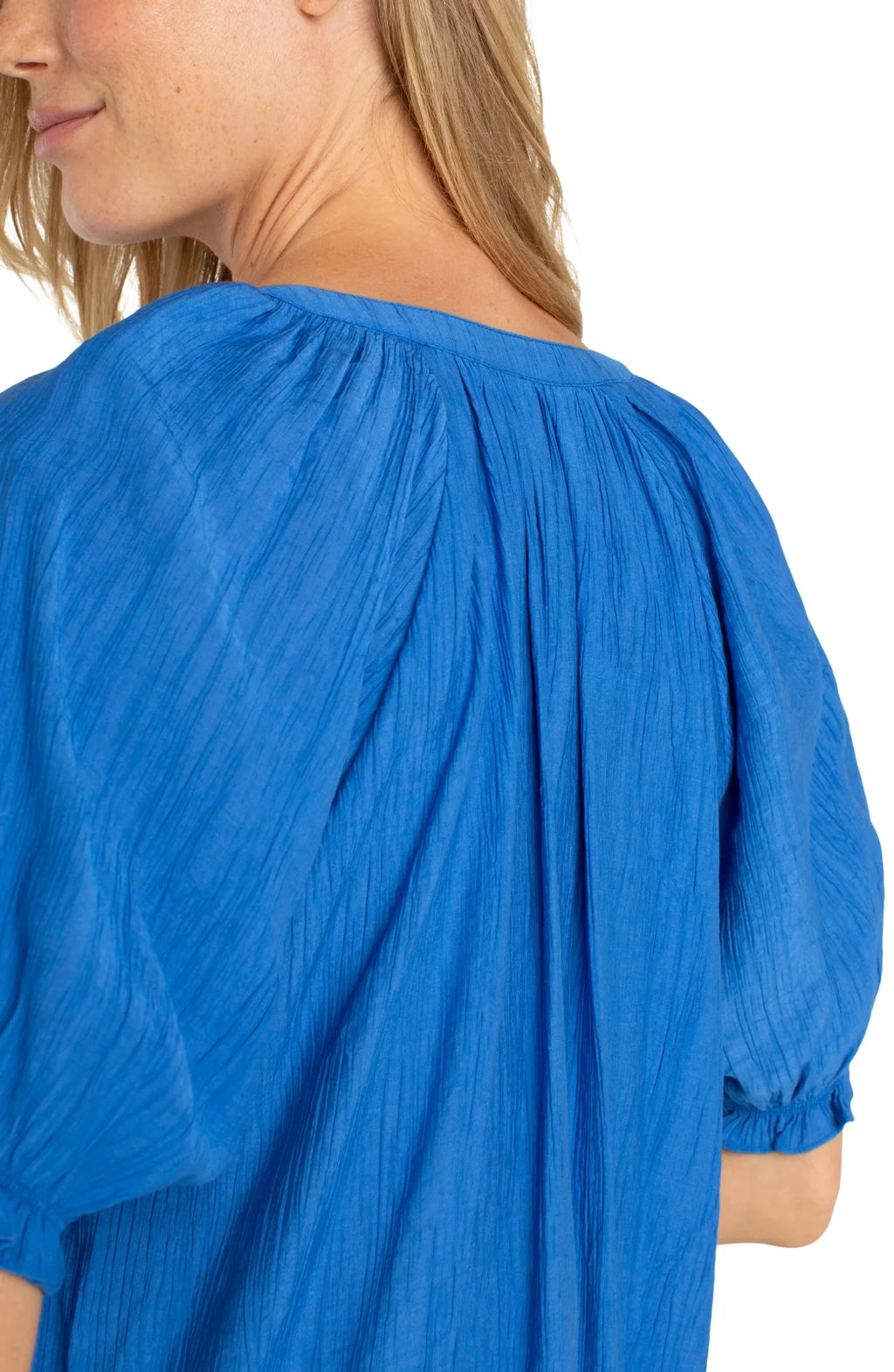 Back view of LP cobalt blue blouse with puff sleeves, perfect for coastal boutique clothing and tropical vacations.