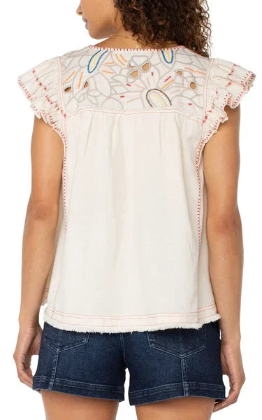 Back view of LP embroidered top with cut-out details, perfect coastal boutique clothing for warm days.