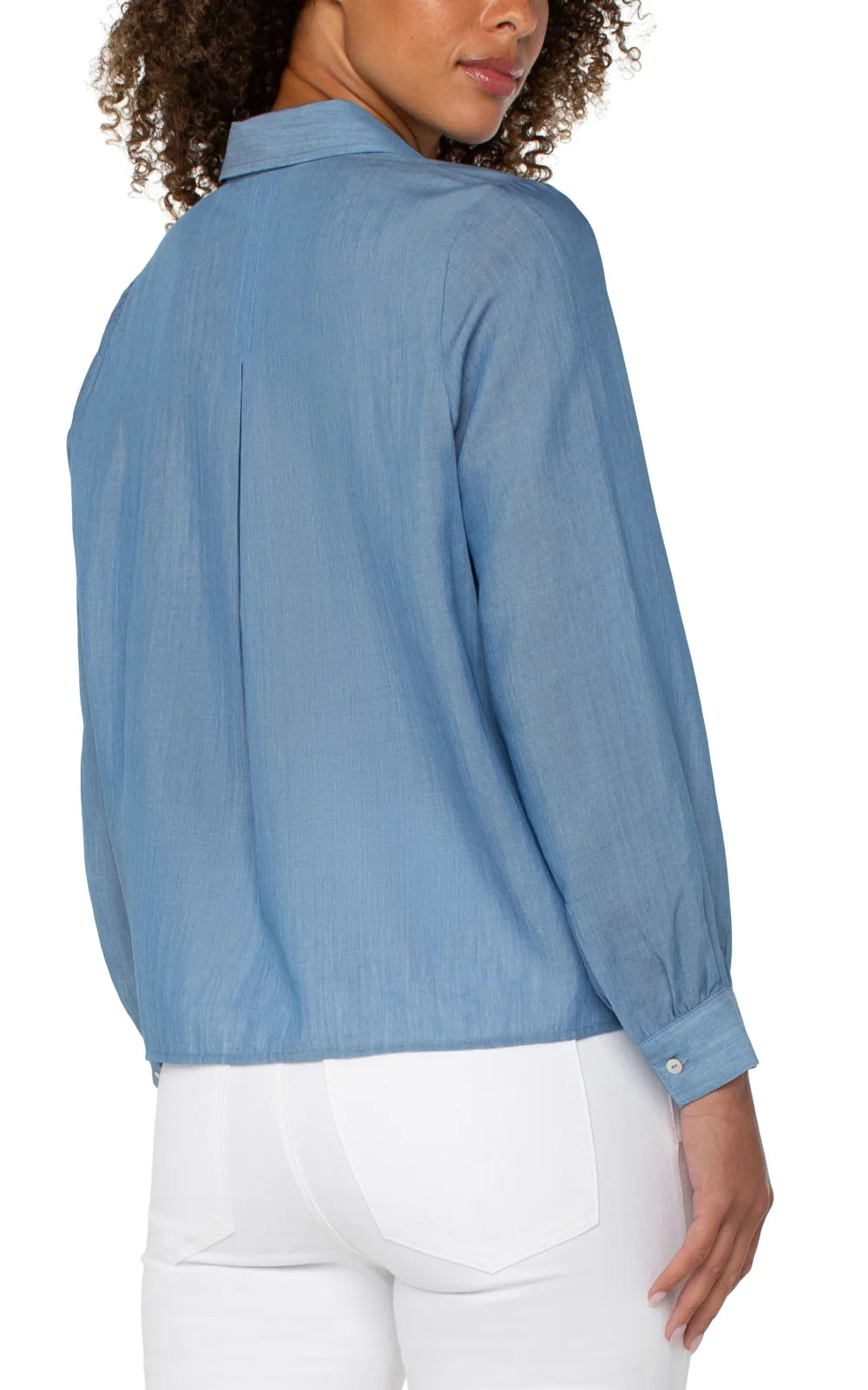 Back view of a stylish blue blouse from Raggdoll Boutique, perfect for summer outfits Texas and coastal fashion.