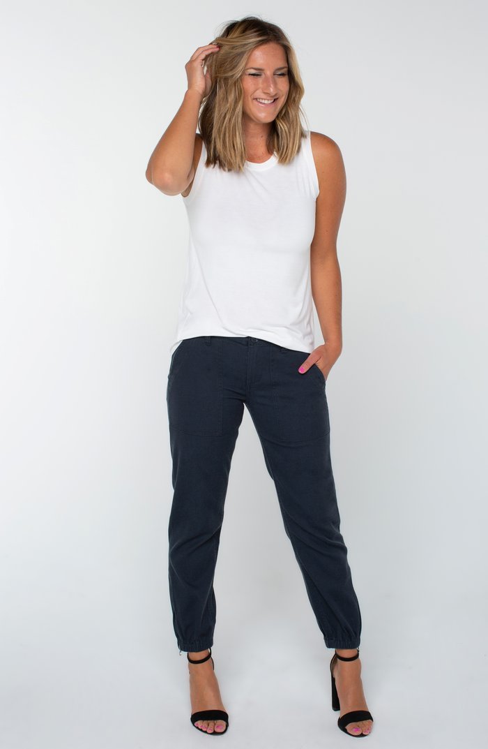 Stylish woman wearing CARBON CLUE UTILITY PANTS from Raggdoll Boutique, perfect for summer outfits Texas.