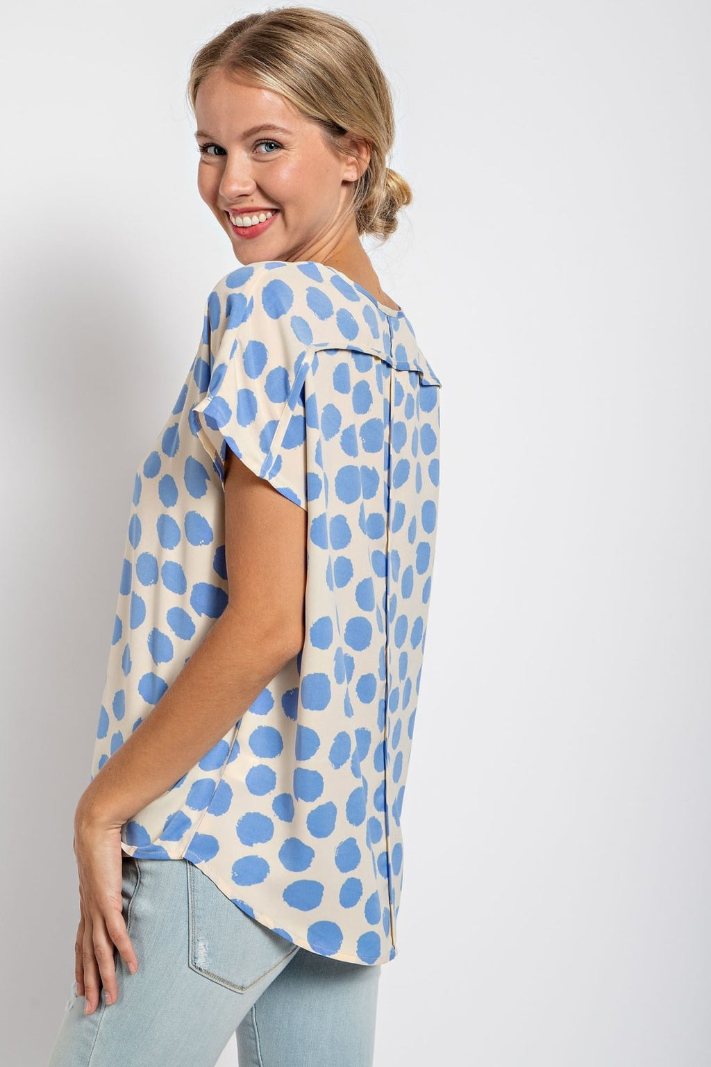 Stylish woman showcasing the CREAM AND BLUE DOT TOP at Raggdoll Boutique, perfect for summer outfits Texas.