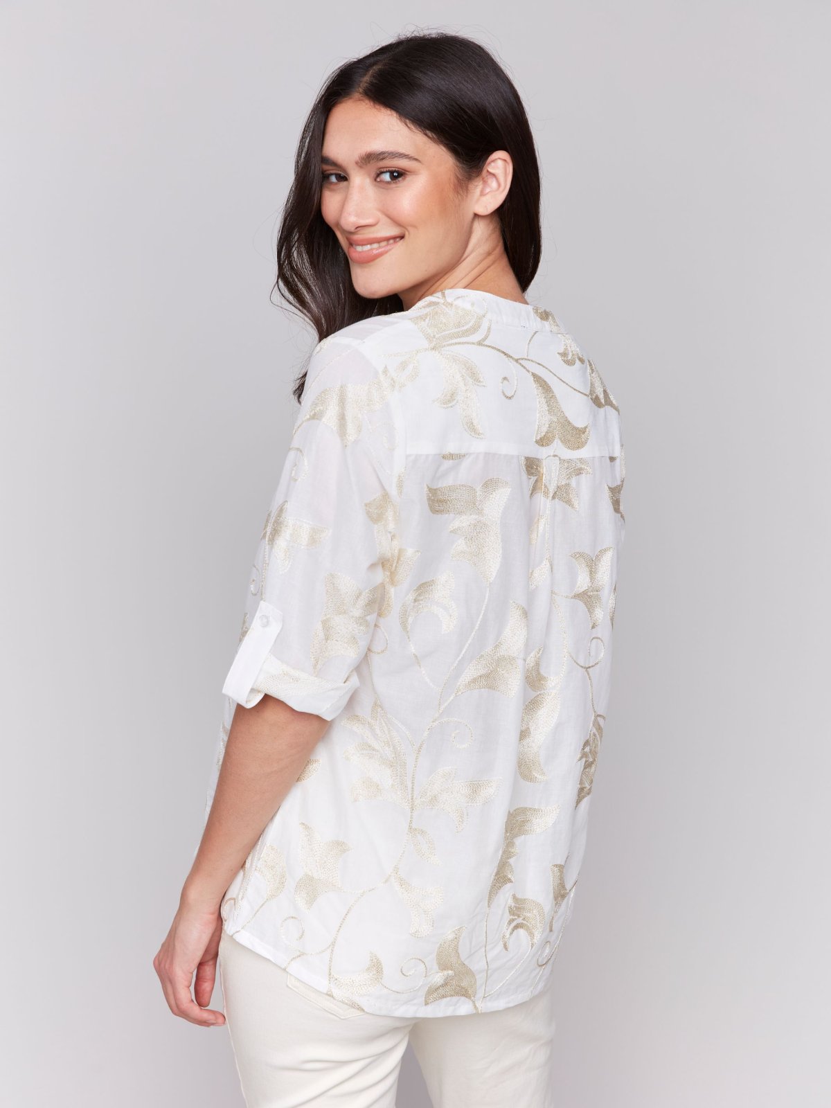 Model wearing a White/Gold Embroidered Gold Top from Raggdoll Boutique, showcasing trendy coastal style.