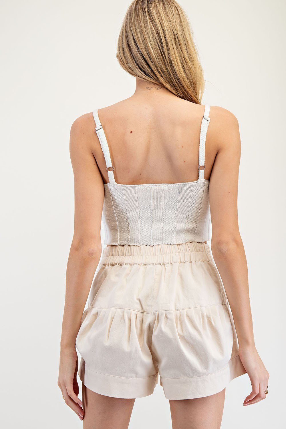 Woman wearing Ecru Button Front shorts with a fitted top, showcasing trendy coastal style from Raggdoll Boutique.