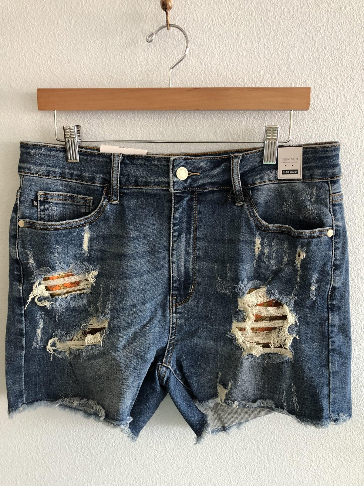 JUDY BLUE PLUS PRINTED PKT LINED CUTOFF SHORTS displayed on a hanger at Raggdoll Boutique, Port Aransas boutique.