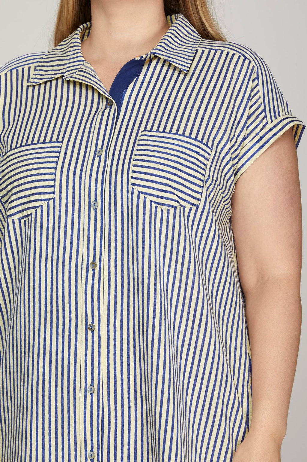 Navy striped dress featuring button-down front, short sleeves, and pockets, ideal for coastal boutique clothing and casual outings.