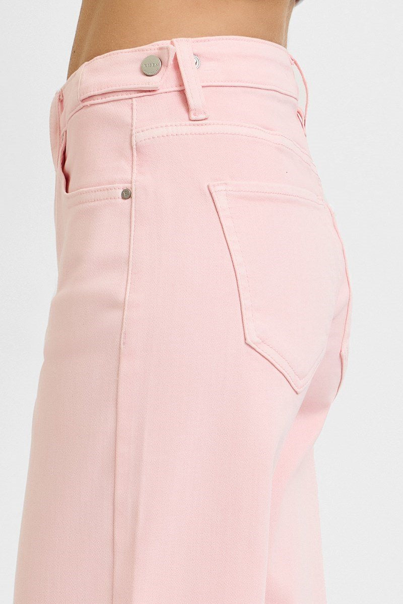Side view of Risen Soft Pink Jeans showcasing mid-rise fit and vibrant color, perfect addition from Port Aransas boutique.