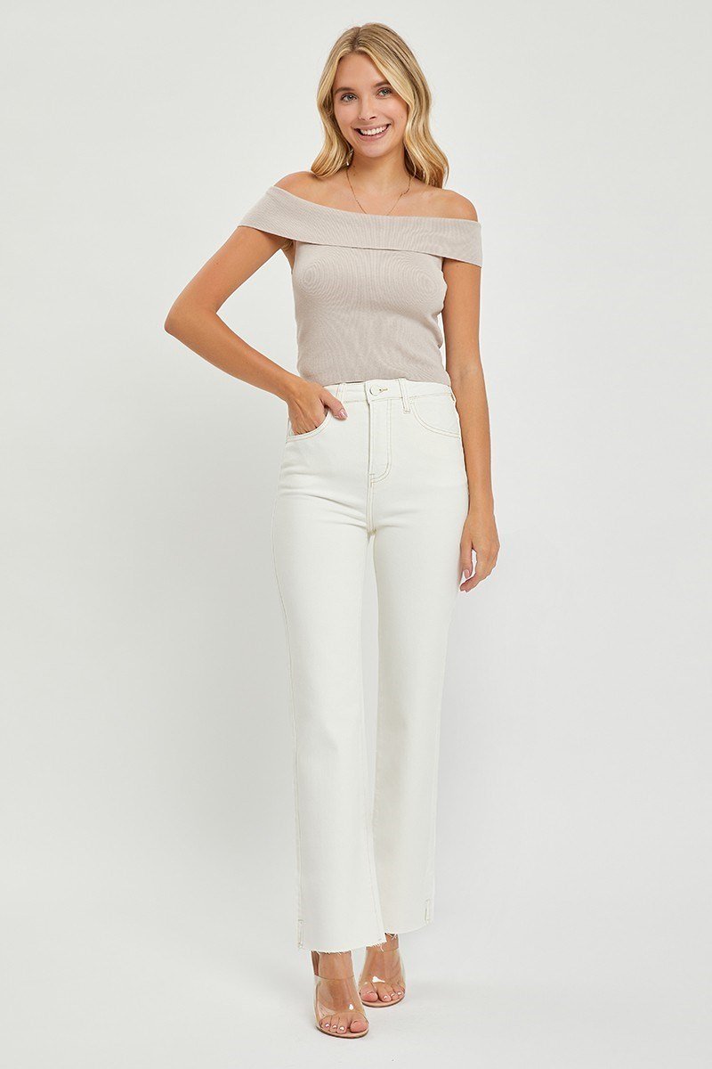 Stylish woman in Risen Cream Jeans paired with a trendy off-the-shoulder top, perfect for coastal boutique clothing.