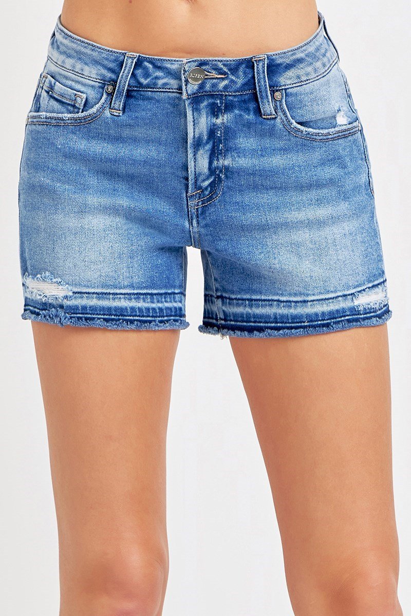 Medium wash low rise denim shorts, perfect for summer beach wear. Stylish shorts from a coastal boutique clothing collection.