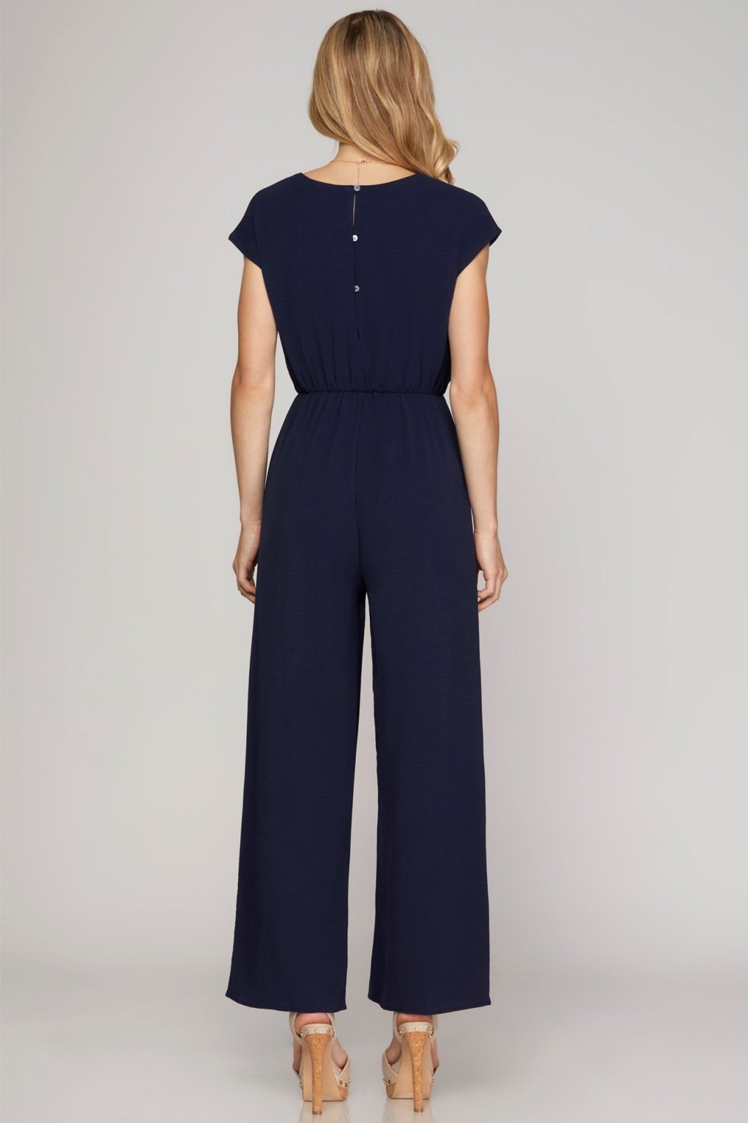Navy Jumpsuit from Raggdoll Boutique showing back view, ideal for trendy coastal style in Port Aransas.