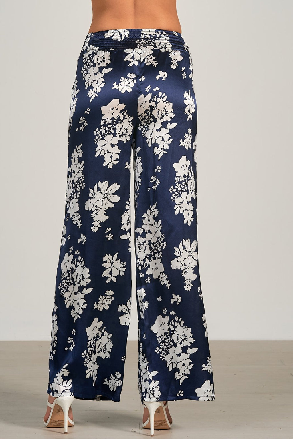 Back view of ELAN CAPRI PRINT NAVY PANTS featuring floral design, perfect for coastal fashion and summer outfits.