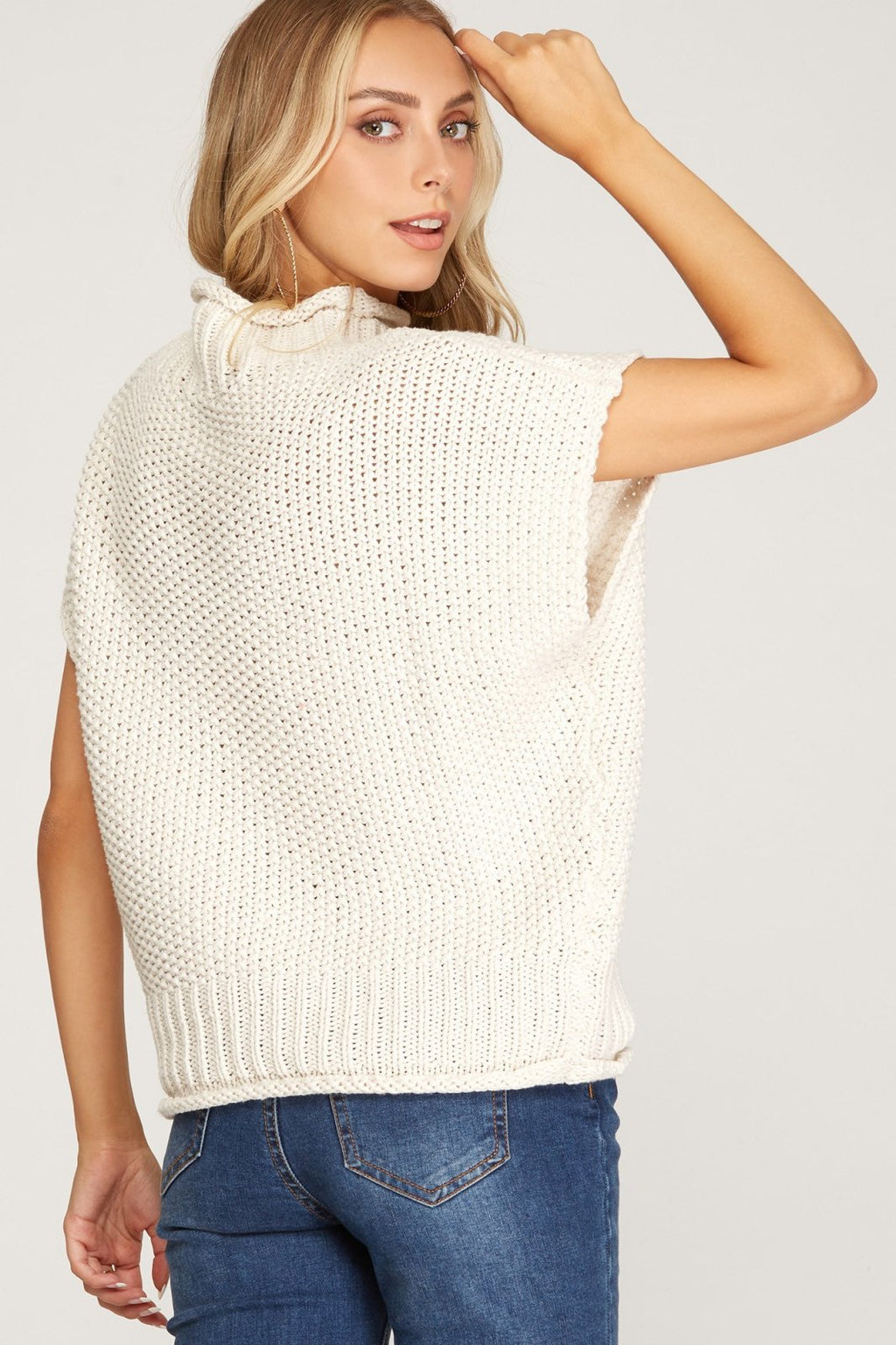 Back view of a model wearing a CREAM MOCK KNIT SWEATER TOP from Raggdoll Boutique, perfect for summer outfits Texas.